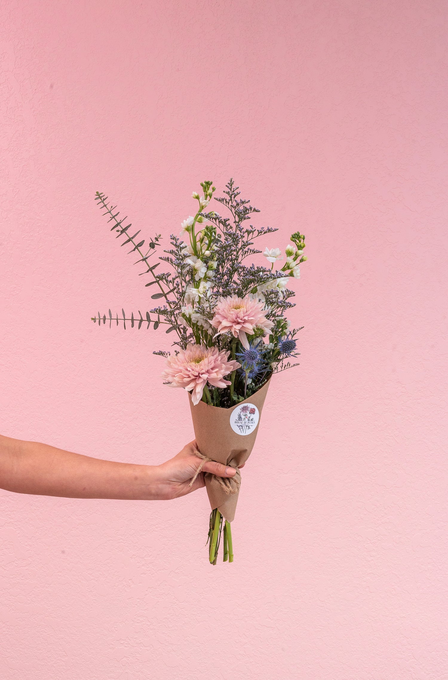 Our petite bouquet is a small posy style arrangement that includes 10-12 stems. Choose a wrapped option with our custom sticker or a vase.