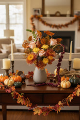 Bouquet of flowers in a vase with a pink background